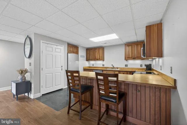 a kitchen with a table chairs and a refrigerator