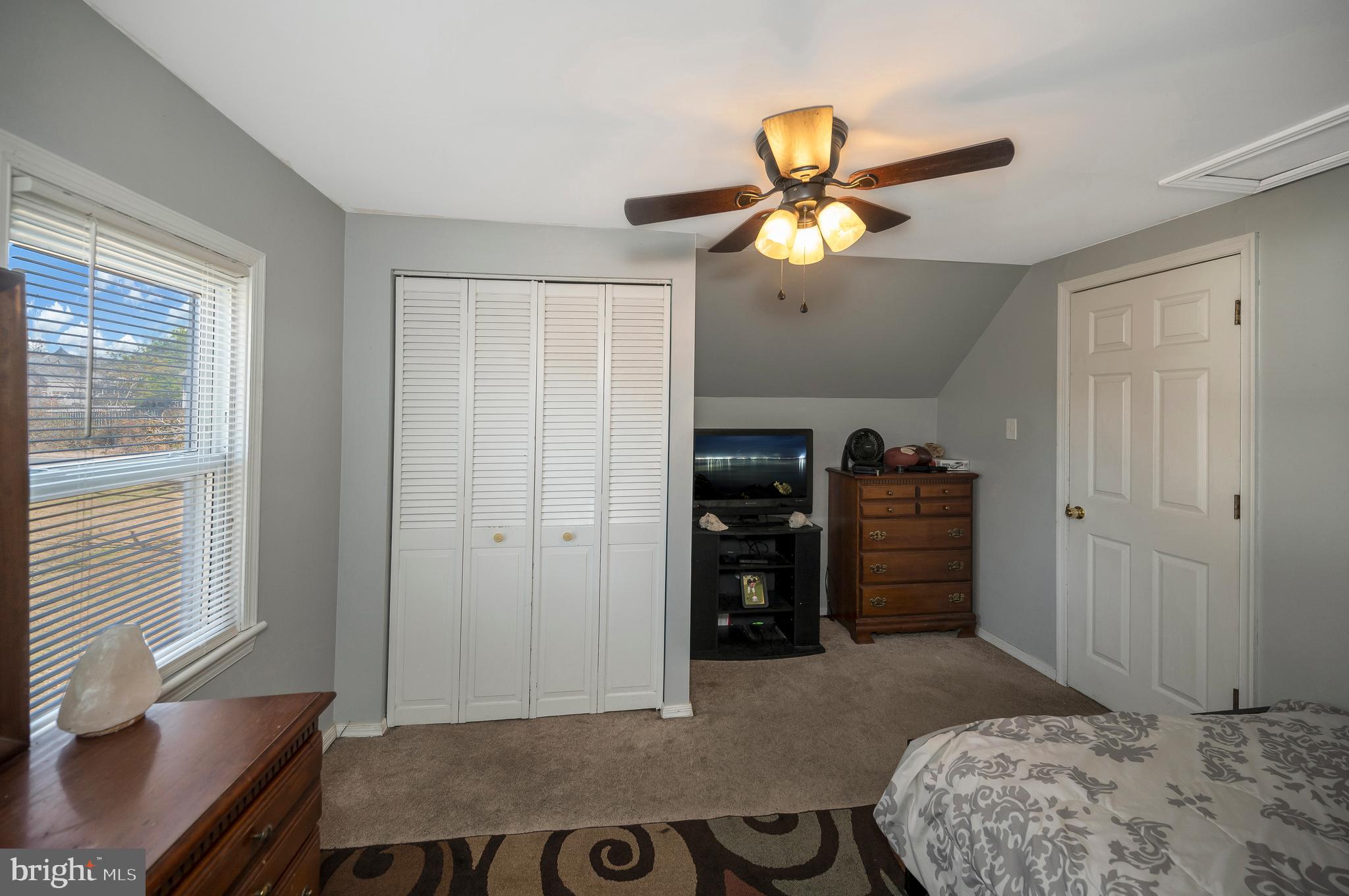 29 Leeland Road Fredericksburg, VA 22405 - Photo 24 of 30 a bedroom with a bed and a chandelier