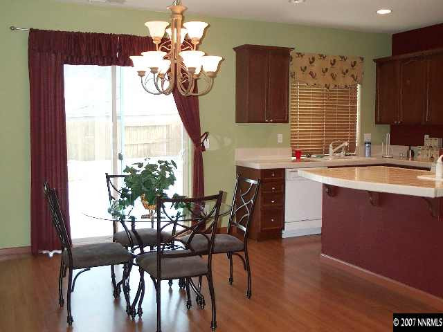 10520 Blockade Drive Reno, NV 89521 - Photo 3 of 9 a dining room filled chandelier and wooden floor