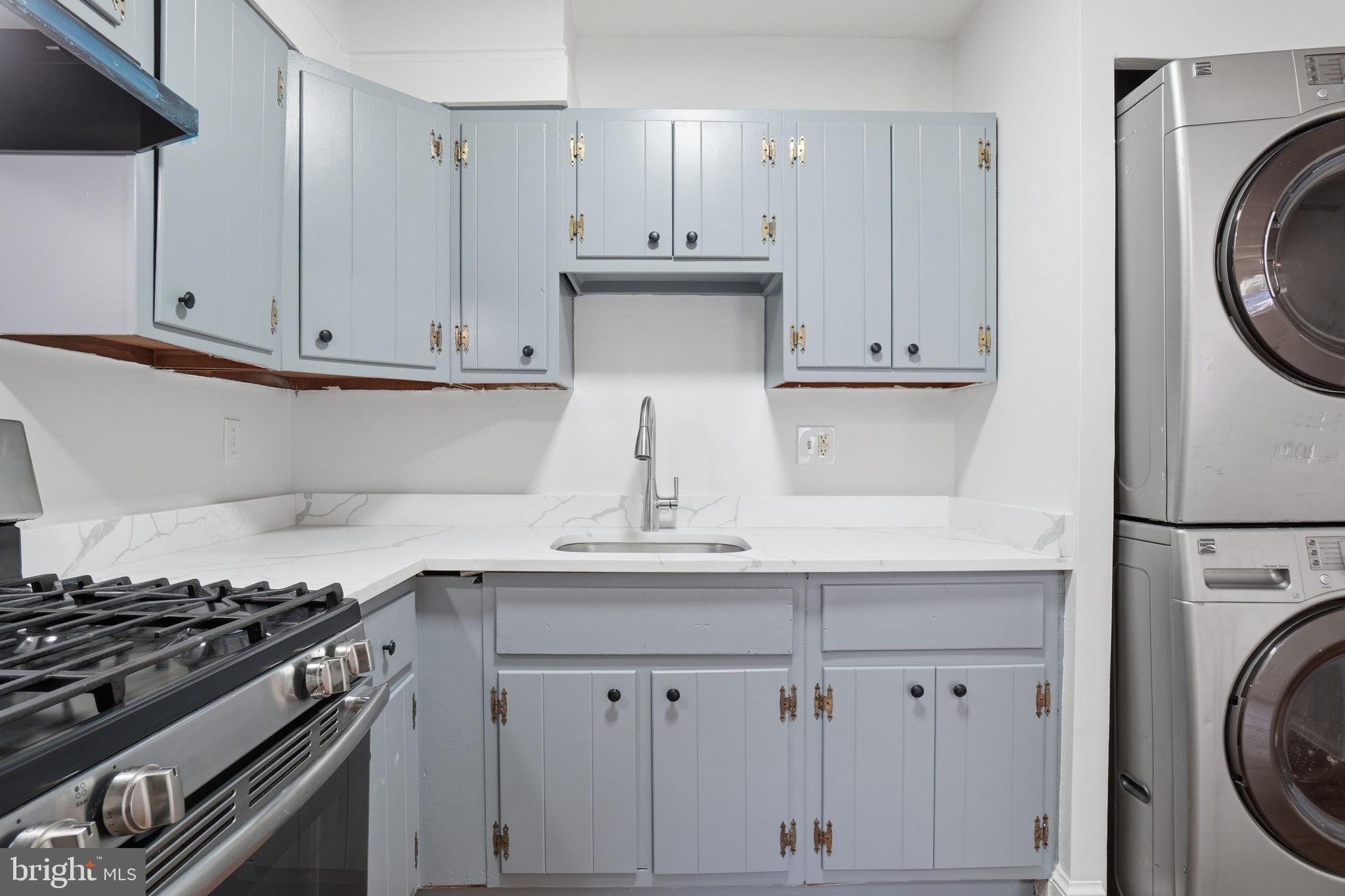 4240 Foote Street Northeast Washington, DC 20019 - Photo 11 of 38 a kitchen with granite countertop white cabinets and stainless steel appliances