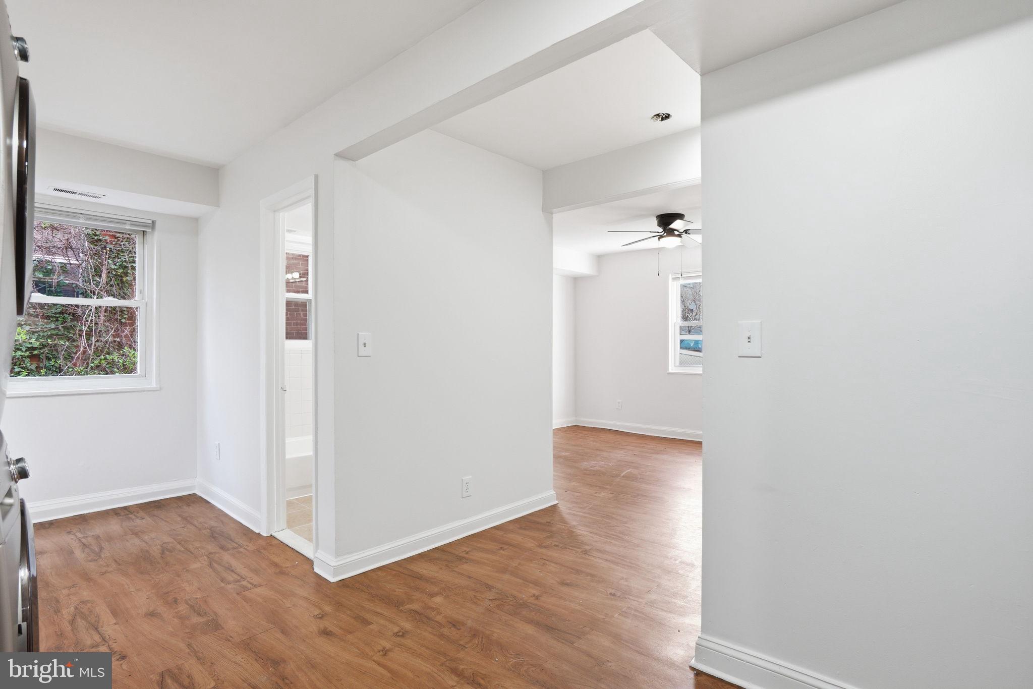 4240 Foote Street Northeast Washington, DC 20019 - Photo 16 of 38 an empty room with wooden floor and windows