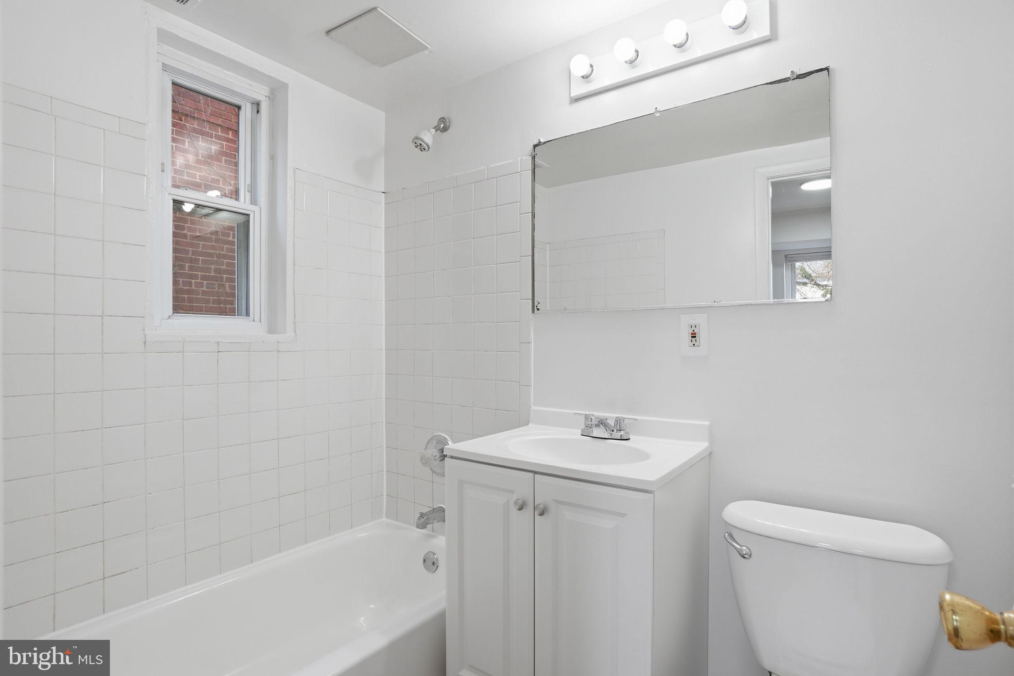 4240 Foote Street Northeast Washington, DC 20019 - Photo 17 of 38 a bathroom with a sink a toilet and shower