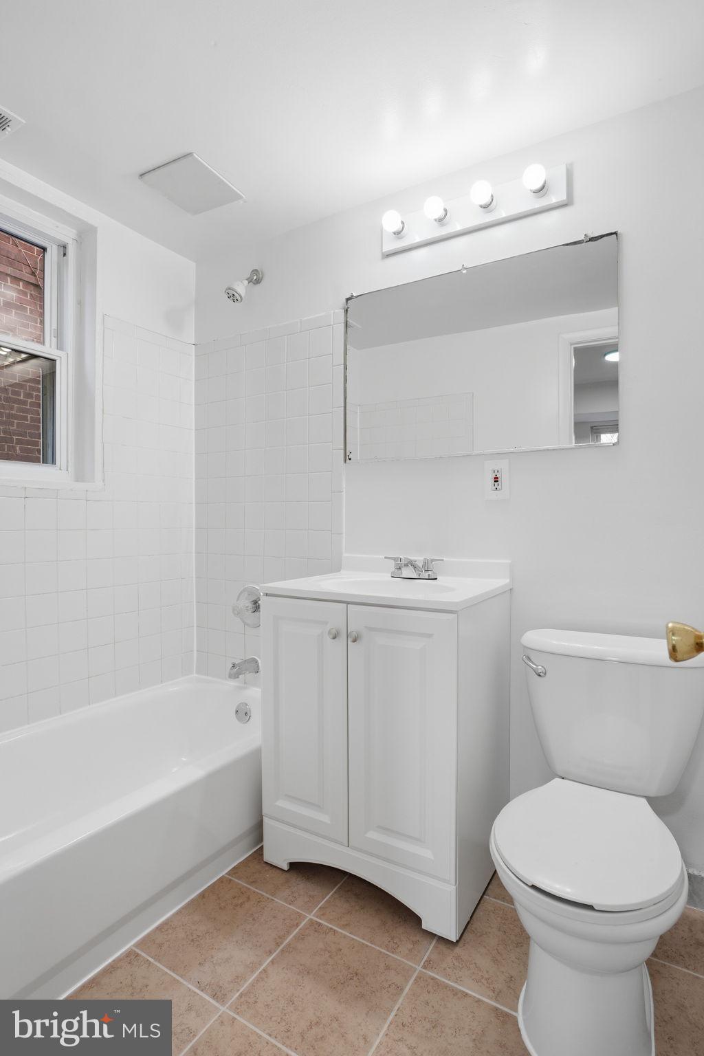 4240 Foote Street Northeast Washington, DC 20019 - Photo 18 of 38 a bathroom with a sink a toilet and bathtub