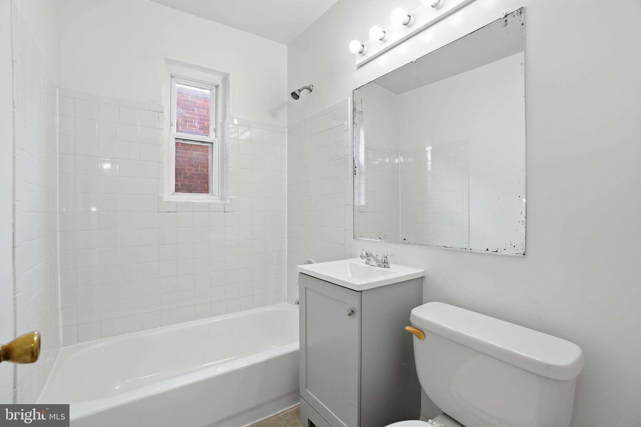 4240 Foote Street Northeast Washington, DC 20019 - Photo 30 of 38 a bathroom with a toilet a sink and bathtub
