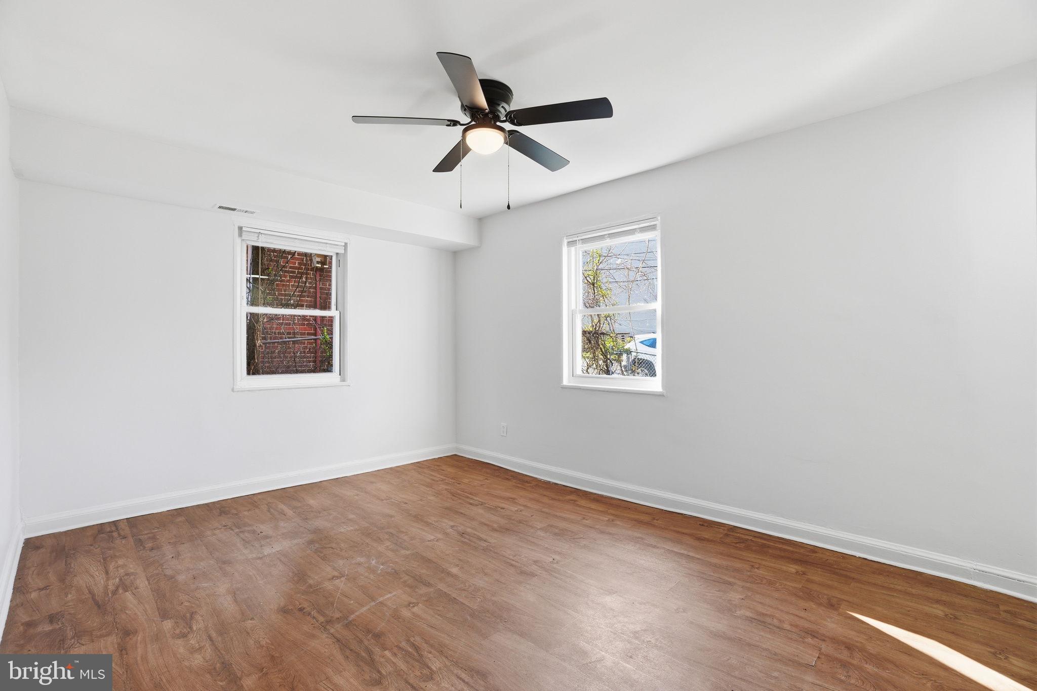 4240 Foote Street Northeast Washington, DC 20019 - Photo 4 of 38 a view of empty room with wooden floor and ceiling fan