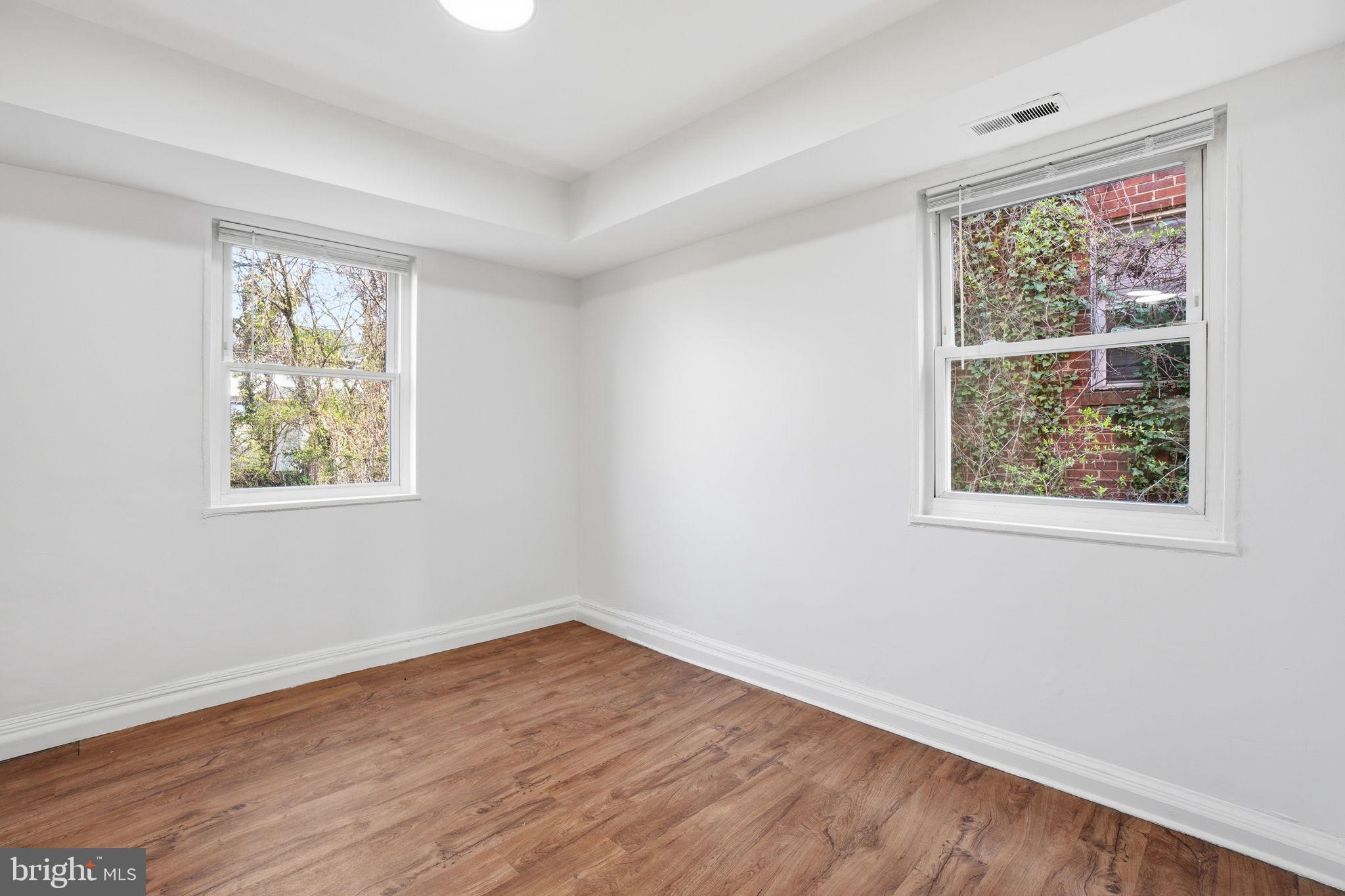 4240 Foote Street Northeast Washington, DC 20019 - Photo 5 of 38 a view of an empty room with wooden floor and a window
