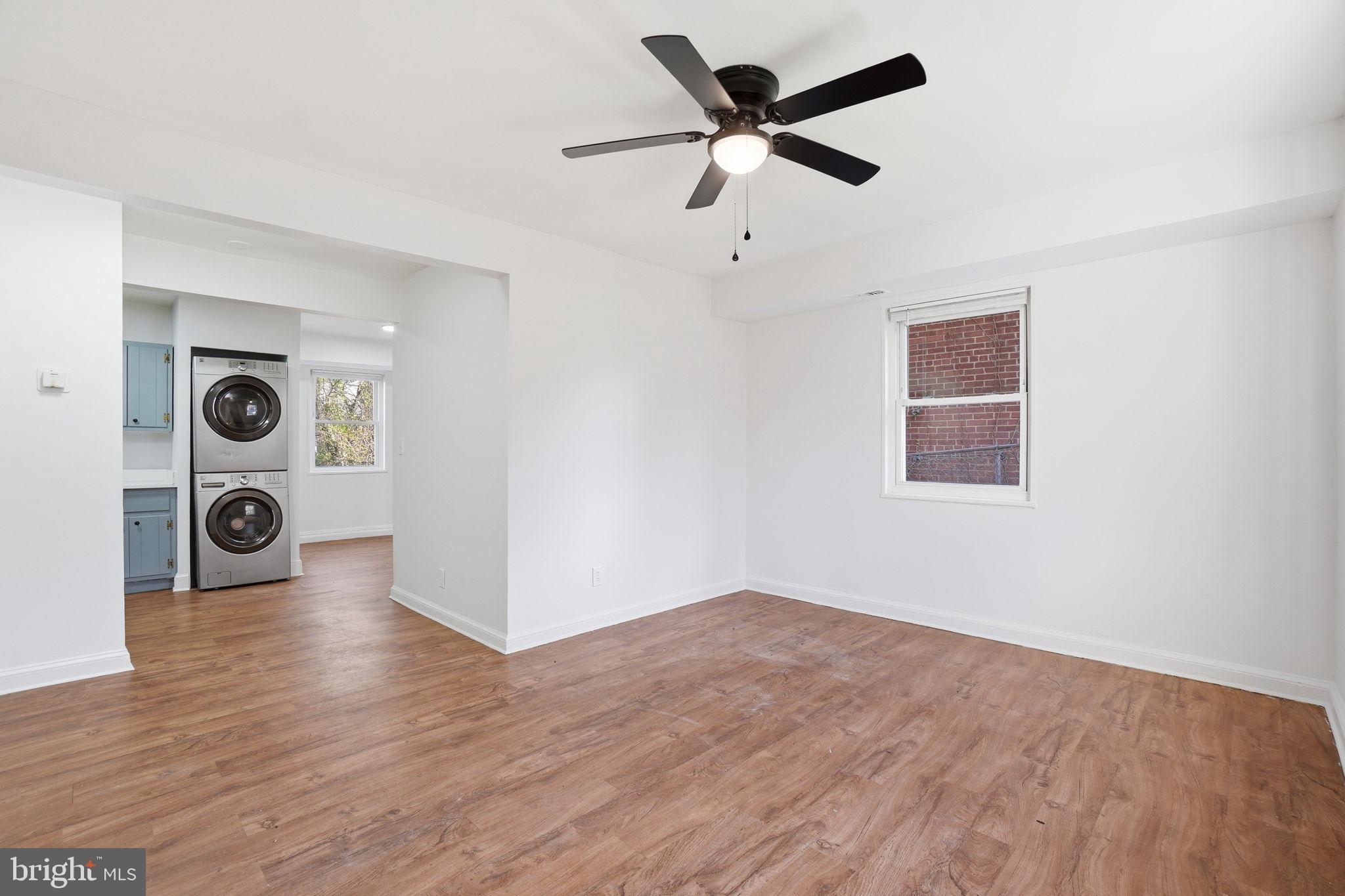 4240 Foote Street Northeast Washington, DC 20019 - Photo 7 of 38 a view of a livingroom with wooden floor and a ceiling fan