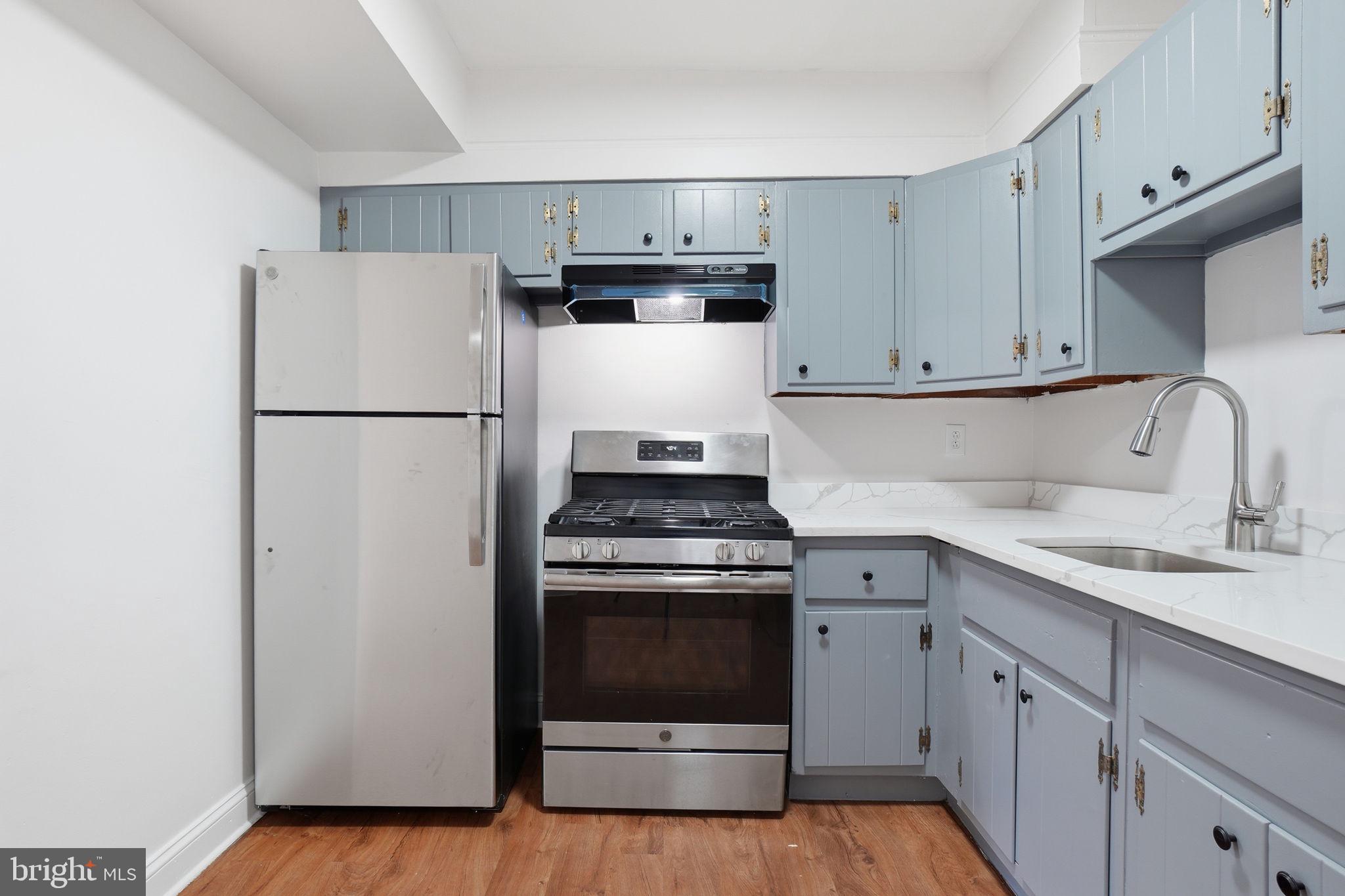 4240 Foote Street Northeast Washington, DC 20019 - Photo 9 of 38 a kitchen with a stove sink and refrigerator