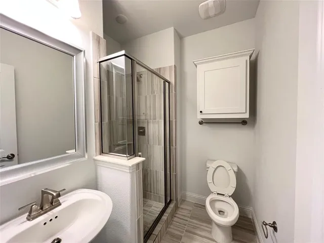 a bathroom with a sink a toilet and a mirror