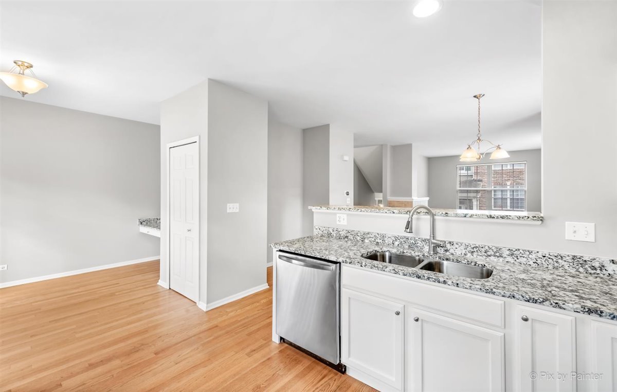 172 East River Road, Unit L Des Plaines, IL 60016 - Photo 13 of 27 a bathroom with a granite countertop sink and mirror