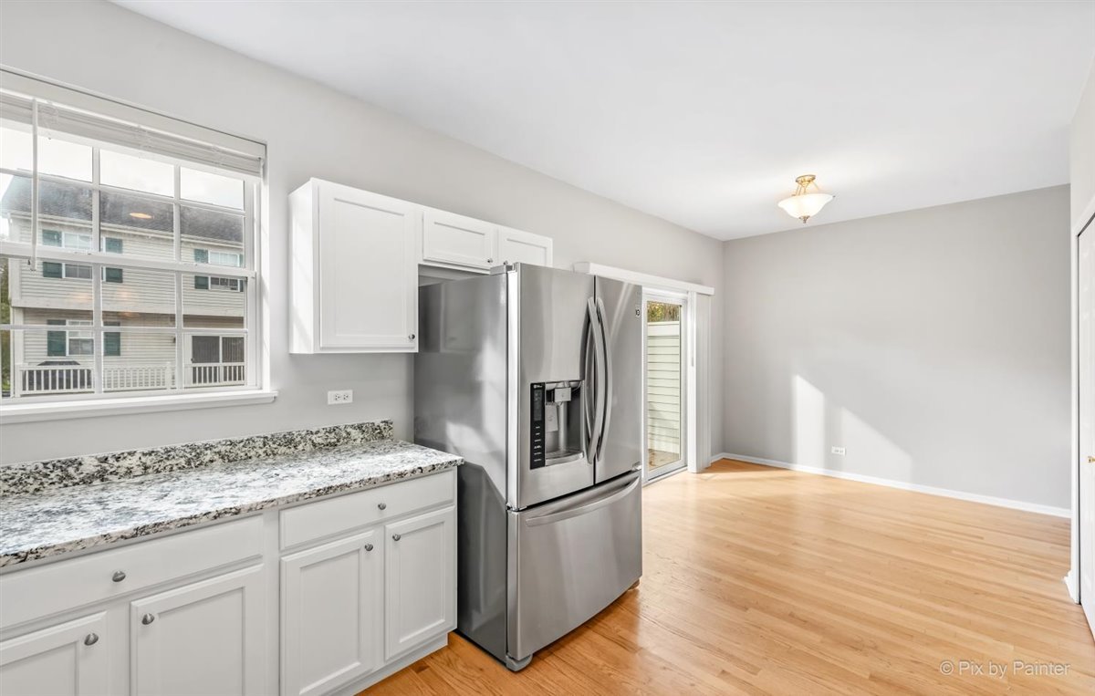 172 East River Road, Unit L Des Plaines, IL 60016 - Photo 14 of 27 a kitchen with stainless steel appliances granite countertop a refrigerator and a stove
