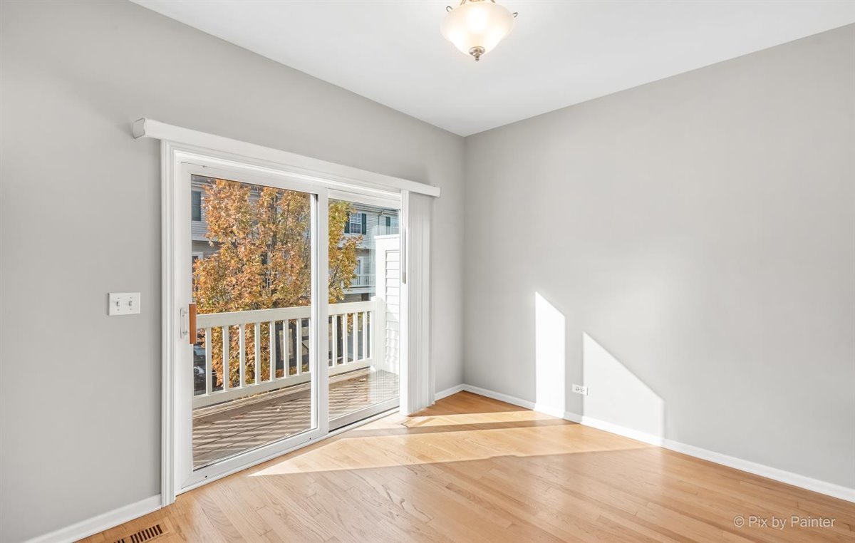 172 East River Road, Unit L Des Plaines, IL 60016 - Photo 15 of 27 a view of an empty room with wooden floor and a window