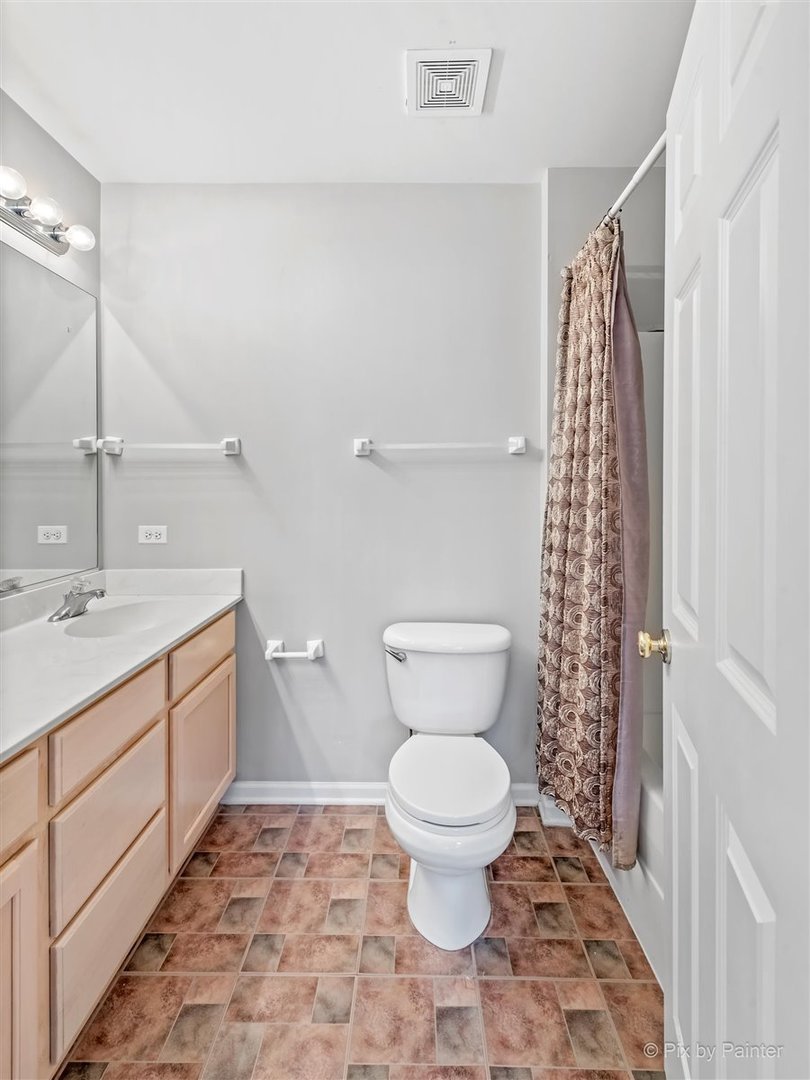 172 East River Road, Unit L Des Plaines, IL 60016 - Photo 19 of 27 a bathroom with a toilet sink and shower