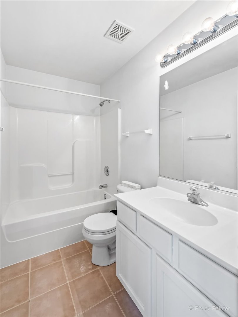 172 East River Road, Unit L Des Plaines, IL 60016 - Photo 20 of 27 a bathroom with a sink toilet and shower