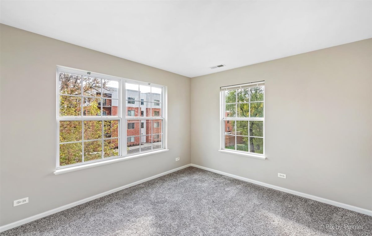 172 East River Road, Unit L Des Plaines, IL 60016 - Photo 23 of 27 an empty room with a window