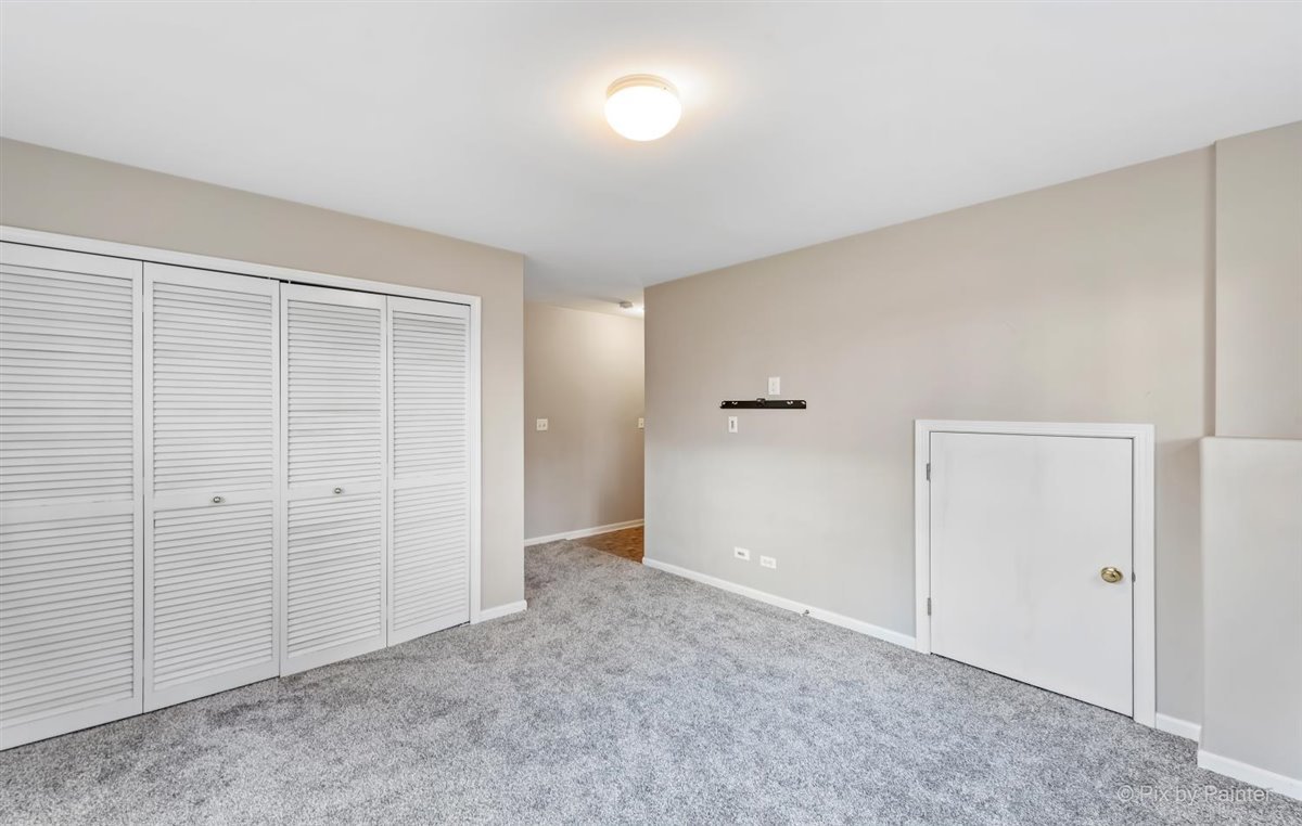 172 East River Road, Unit L Des Plaines, IL 60016 - Photo 26 of 27 an empty room with closet area