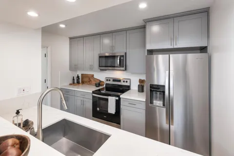 a kitchen with a refrigerator microwave and stove