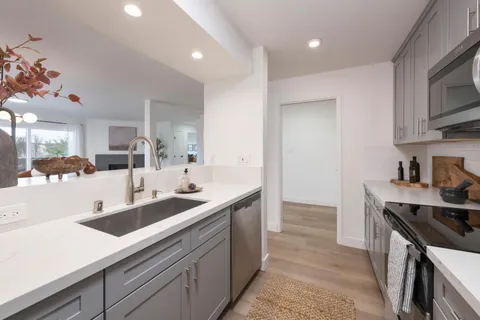 a kitchen with granite countertop a sink and cabinets