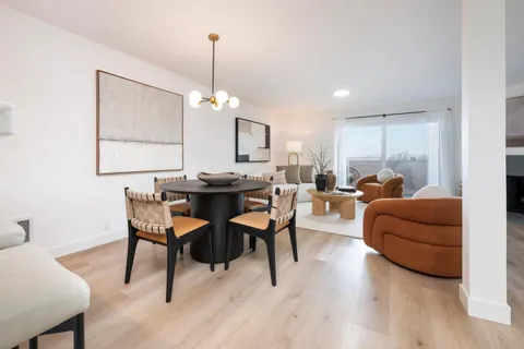 a living room with furniture a table and a chandelier