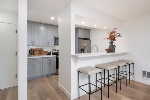 a kitchen with a table and chairs in it