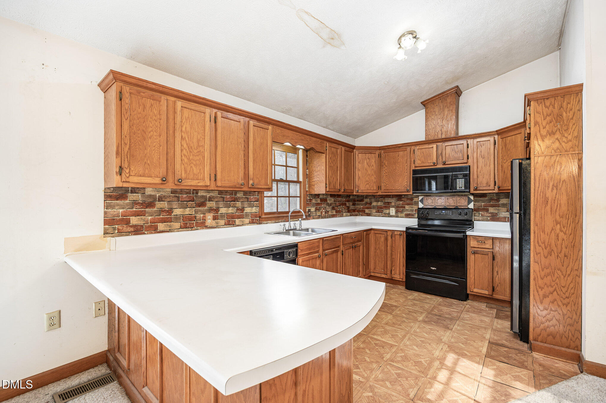 227 Bellview Road Robbins, NC 27325 - Photo 7 of 20 a large kitchen with kitchen island a large counter top space a sink stainless steel appliances and cabinets