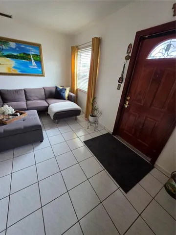 a living room with furniture and a mirror