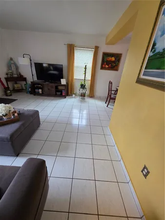 a living room with furniture and wall painting