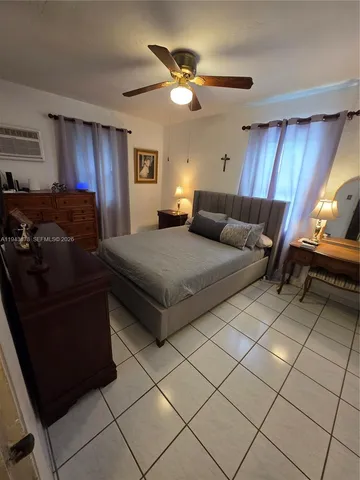 a bedroom with a bed and a ceiling fan