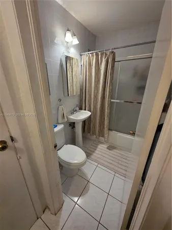 a bedroom with a bed and a mirror