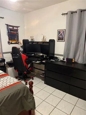 a bedroom with a bed and a desk