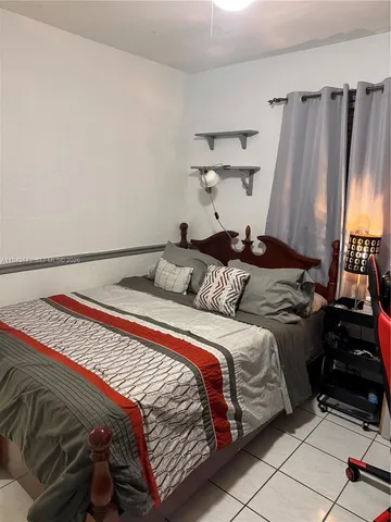 a bedroom with a bed and a mirror