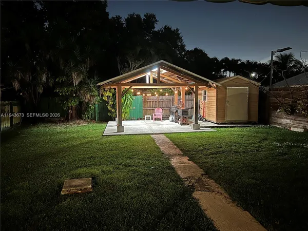 a view of an house with backyard space and garden