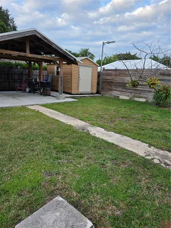 a view of a house with a yard and sitting area