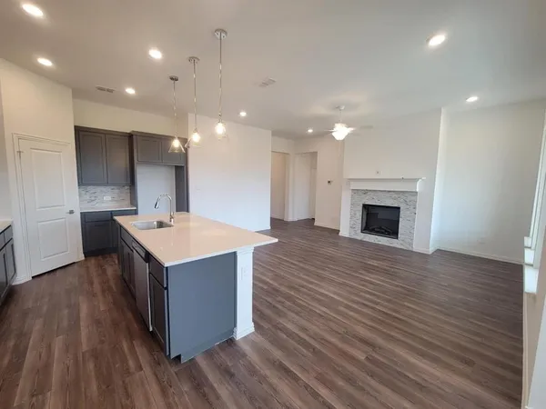 a kitchen with a sink and a fireplace
