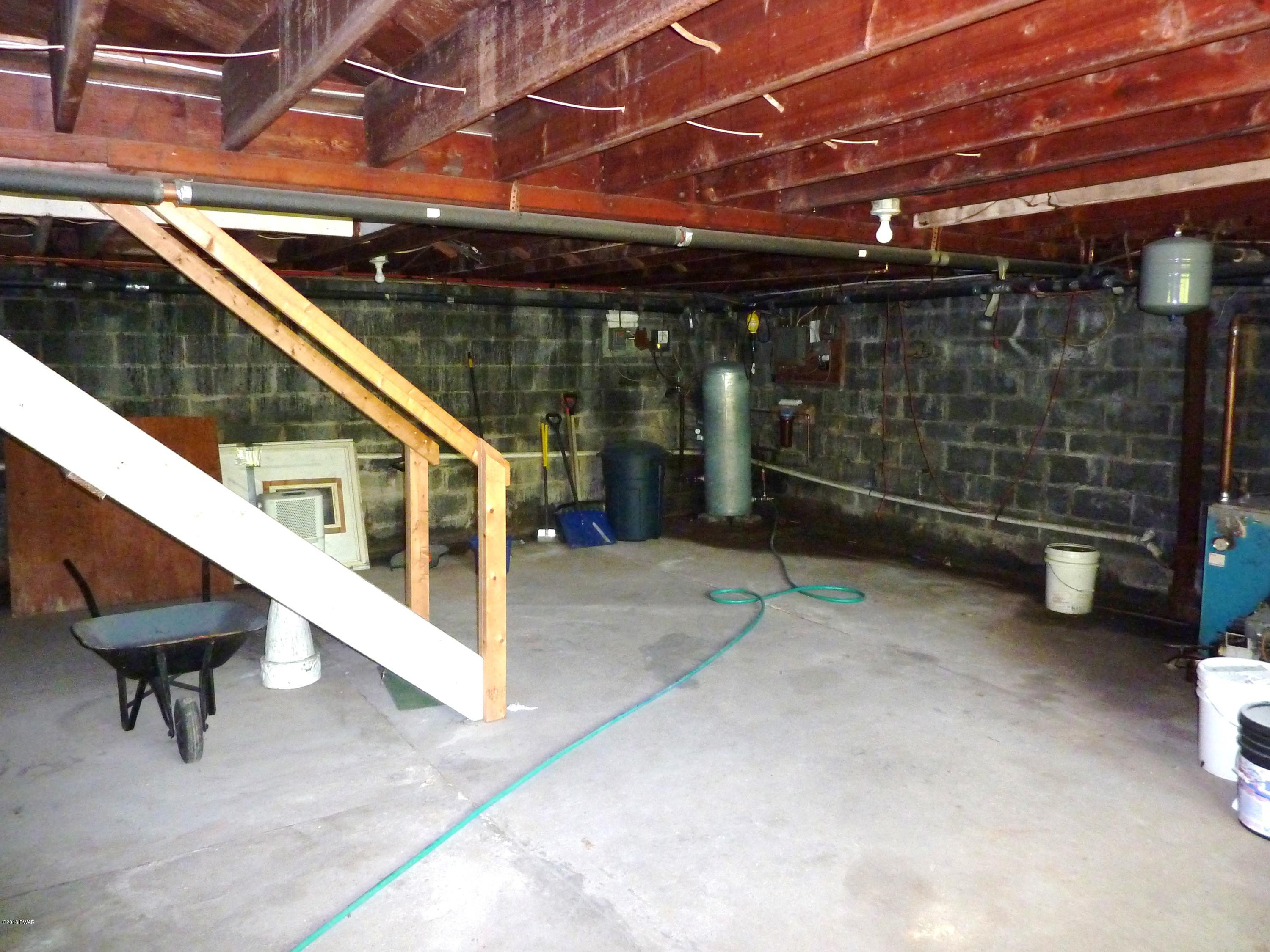 27 E Road Hawley, PA 18428 - Photo 18 of 22 a view of a balcony with a couch and wooden floor