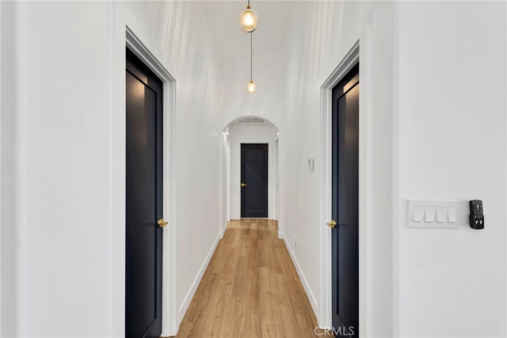 8038 Begonia Road Phelan, CA 92371 - Photo 19 of 49 a view of a hallway with wooden floor and staircase