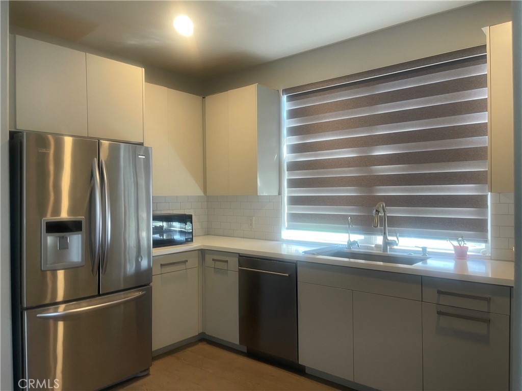 835 Francesca Drive, Unit 201 Walnut, CA 91789 - Photo 4 of 12 a kitchen with stainless steel appliances granite countertop a refrigerator and a sink