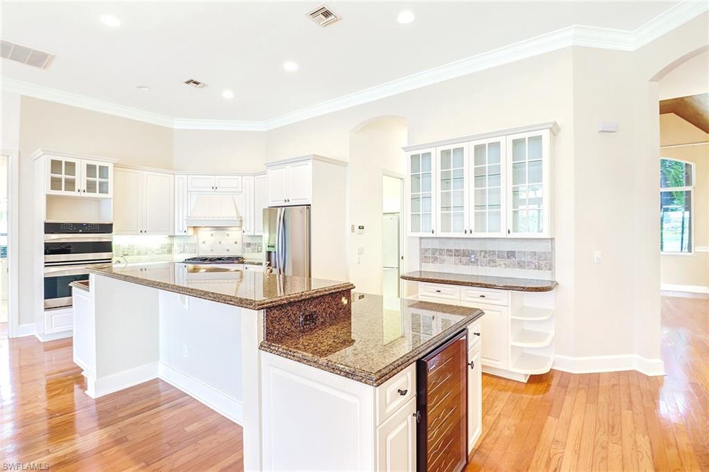 263 Monterey Drive Naples, FL 34119 - Photo 12 of 35 a kitchen with stainless steel appliances granite countertop a sink stove and refrigerator