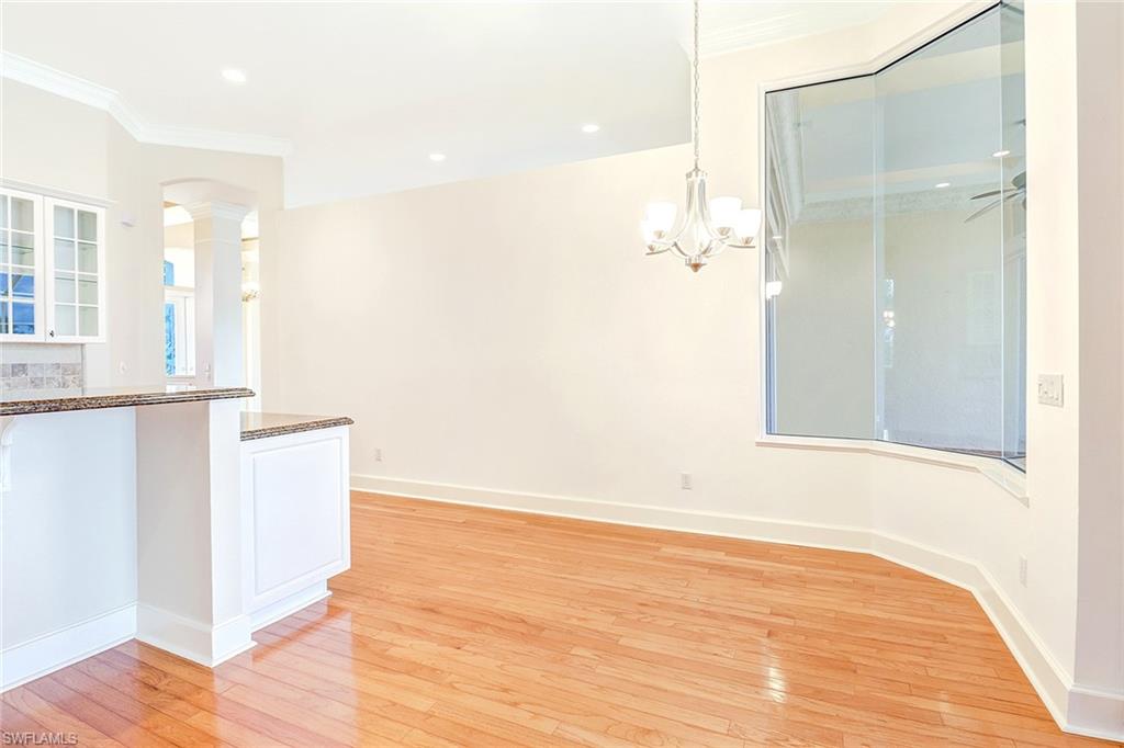 263 Monterey Drive Naples, FL 34119 - Photo 15 of 35 an empty room with wooden floor and windows