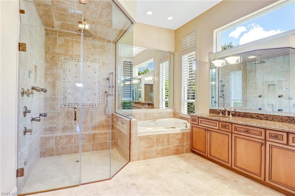 263 Monterey Drive Naples, FL 34119 - Photo 20 of 35 a large bathroom with a tub sink shower and mirror