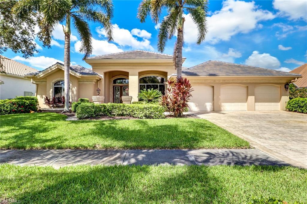 263 Monterey Drive Naples, FL 34119 - Photo 2 of 35 a front view of a house with garden