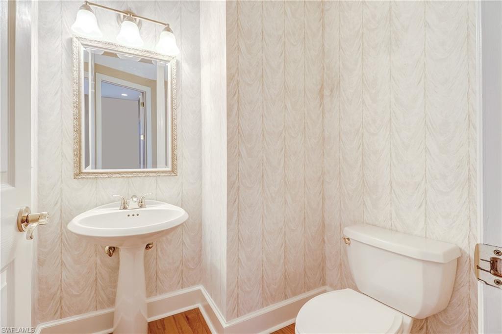263 Monterey Drive Naples, FL 34119 - Photo 21 of 35 a bathroom with a toilet sink and mirror