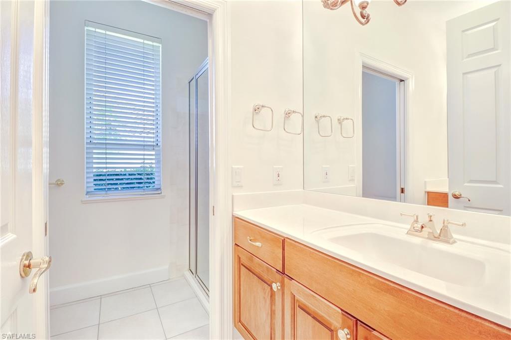 263 Monterey Drive Naples, FL 34119 - Photo 23 of 35 a bathroom with a sink and a mirror