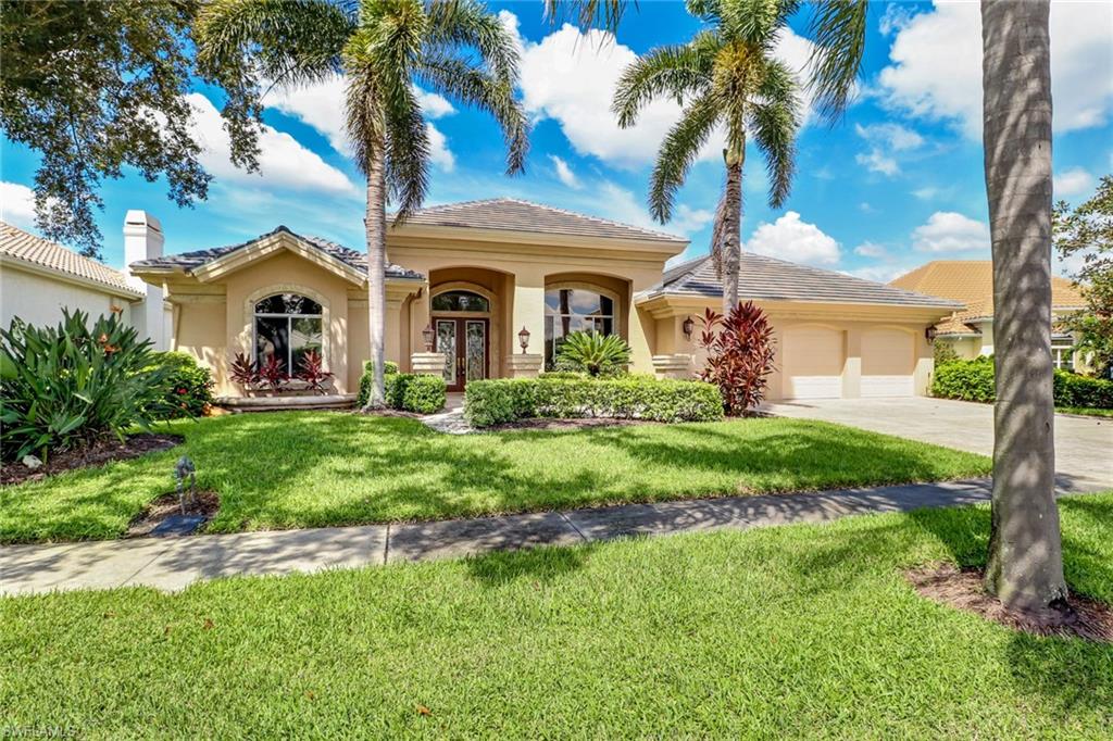 263 Monterey Drive Naples, FL 34119 - Photo 32 of 35 a front view of a house with a garden and plants