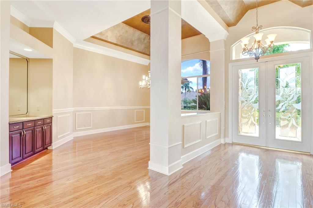 263 Monterey Drive Naples, FL 34119 - Photo 4 of 35 a view of a hallway with wooden floor and cabinet