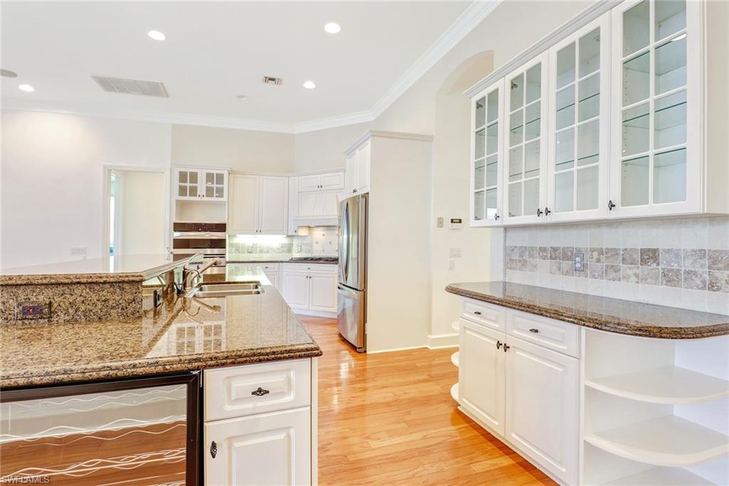 263 Monterey Drive Naples, FL 34119 - Photo 10 of 35 a kitchen with granite countertop a sink and cabinets