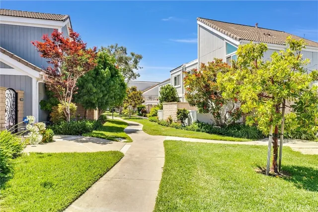 a view of a fountain in front of a house with a big yard