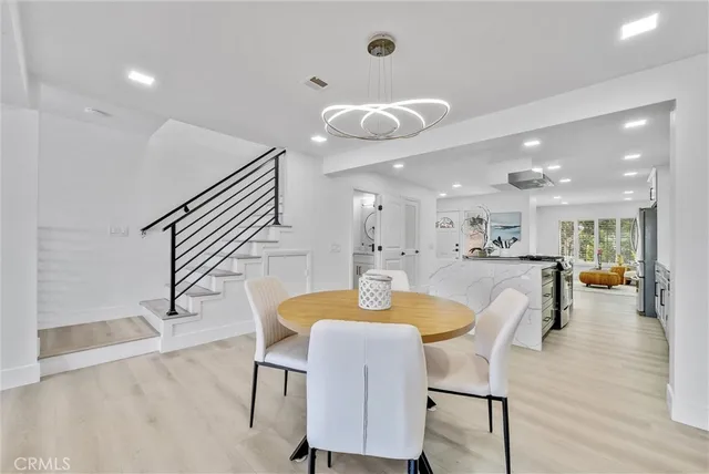 a view of a hallway with wooden floor and stairs