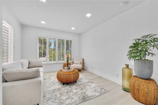 a view of a hallway with closet and wooden floor