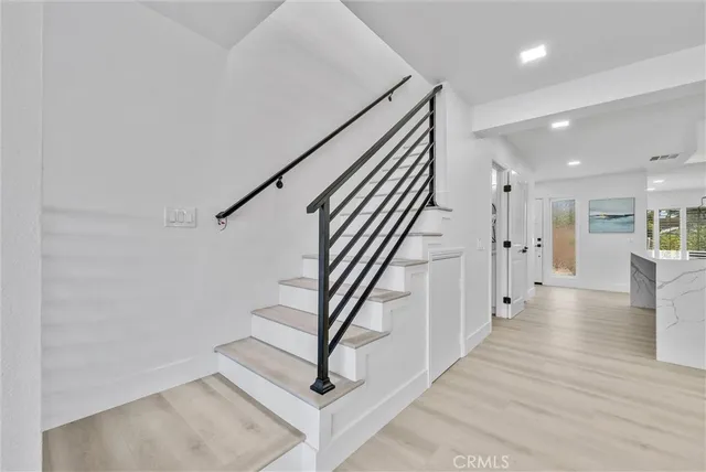 an empty room with a ceiling fan and carpet